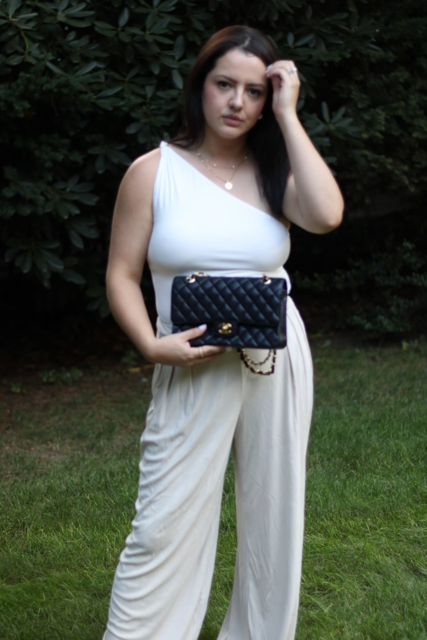 Amanda Kahan, founder of M'llice, holding a black quilted Chanel flap bag